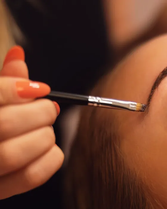 Brow being shaped with a fine angled brush.