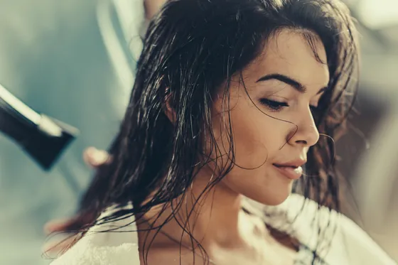 Hair being blow-dried and shaped in the salon.