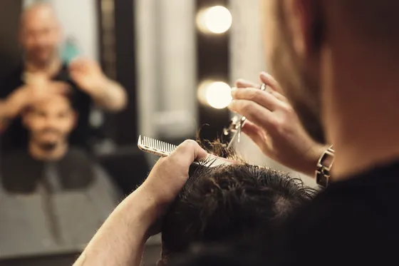 Client having his hair cut and styled at the salon.