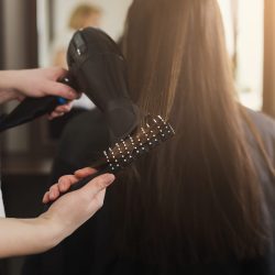 Beautician drying woman's hair after giving a new haircut at salon. Beauty, care, hair cocnept