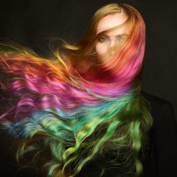 Portrait of young beautiful woman with long flowing hair. Model with perfect Healthy Dyed Hair. Rainbow Hairstyles